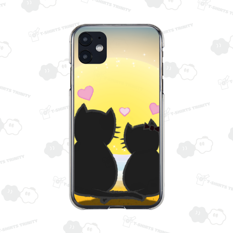 夕暮れの浜辺に座る猫